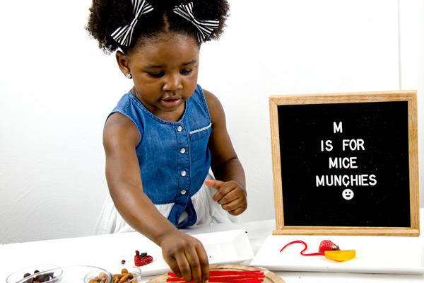 Preschooler assembling mice munchie
