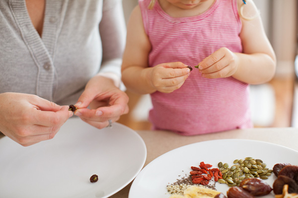 Mom and preschooler assembling snack