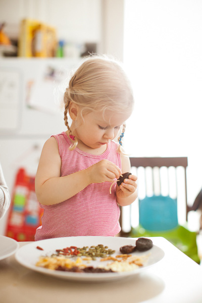Preschooler assembling snack
