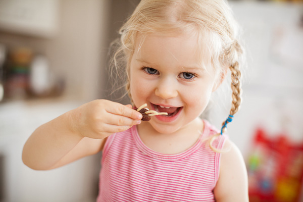 Happy preschooler eating snack