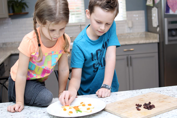 Children assembling butterfly snack