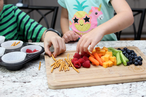 Children sorting through fruit and veggies