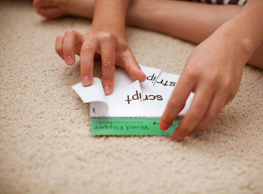 closeup of boy playing with a word flipper