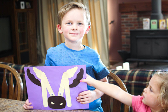 children showing their completed letter m craft
