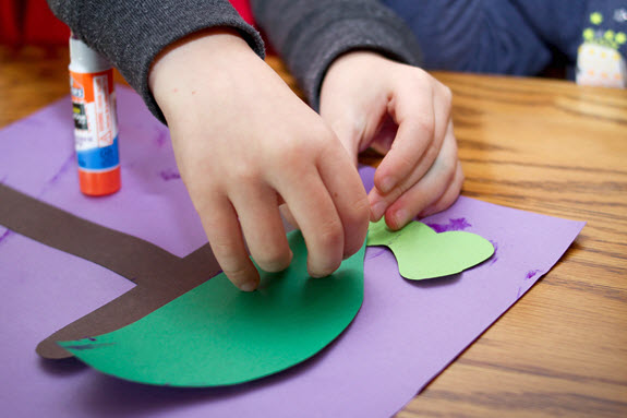 boy gluing his letter T turtle craft