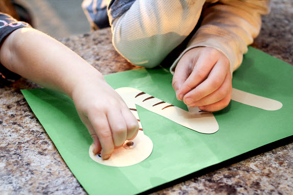 children gluing letter w craft