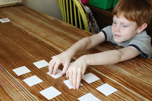 boy selects rhyming activity cards