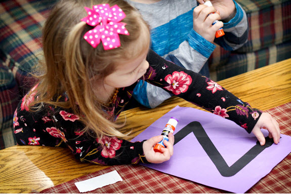 girl glues her letter z craft