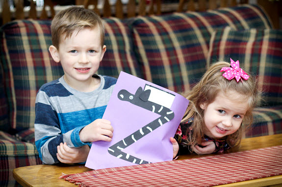 children show their finished zebra craft