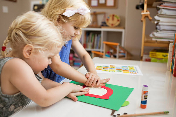 girls assembling lowercase a craft