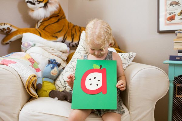 little girl with her finished lowercase a craft