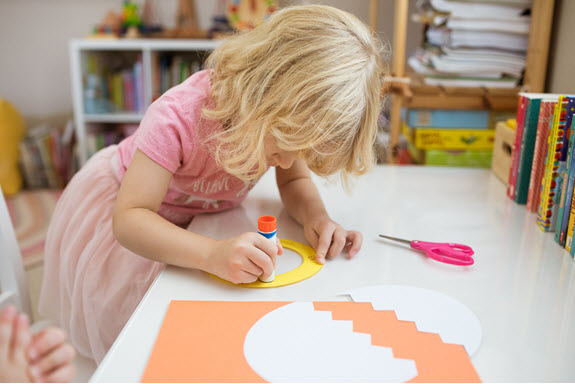 girl assembles lowercase e craft