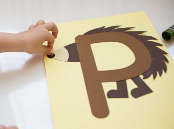 child attaches nose to uppercase P craft