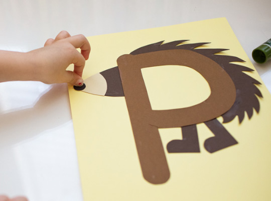 child attaches nose to uppercase P craft