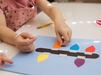 child adds light to lowercase L craft
