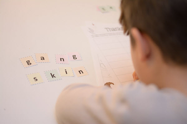 Boy creates words in Thanksgiving Scramble