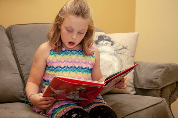 girl reads her advent calendar book