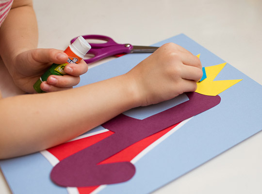 child applies jewel to lowercase q craft