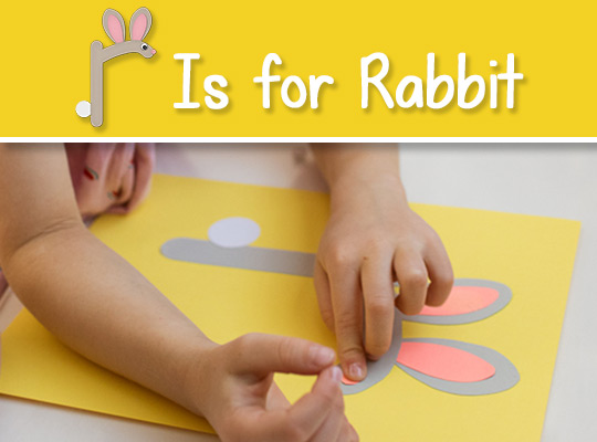 child glues nose to her lowercase r craft
