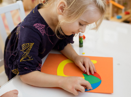 child assembling her lowercase u craft