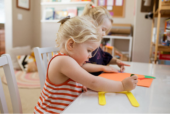 child glues her lowercase u craft