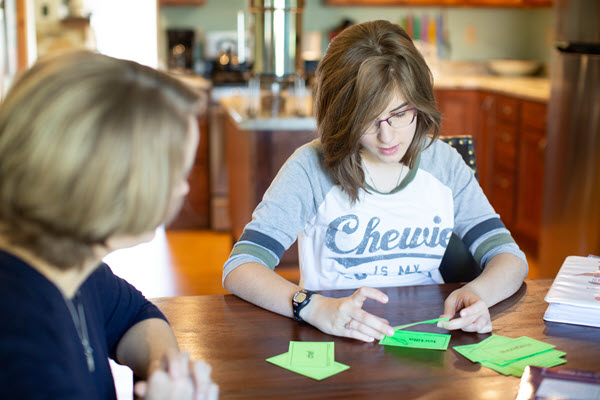 mom and teenager working on word cards