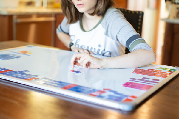 teen using letter tiles
