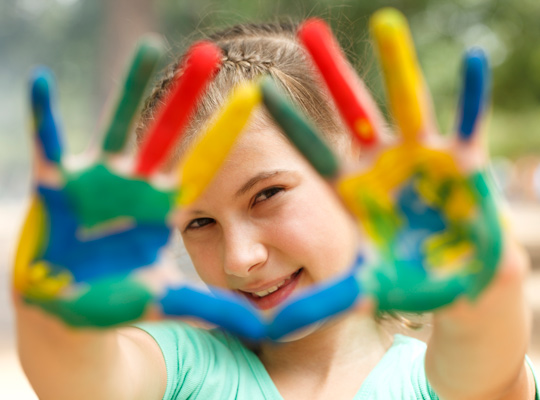 young girls with paint on her hands