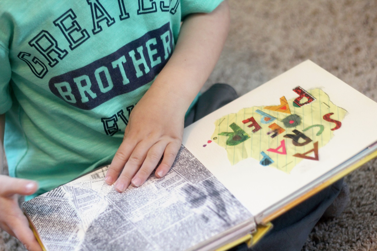 A close-up of a child reading the Beautiful Oops! interactive picture book